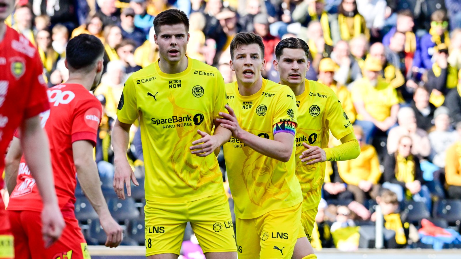 Oscar Kapskarmo, Jostein Gundersen og Nino Zugelj før en corner mot LSK. Foran står to LSK-spillere.  