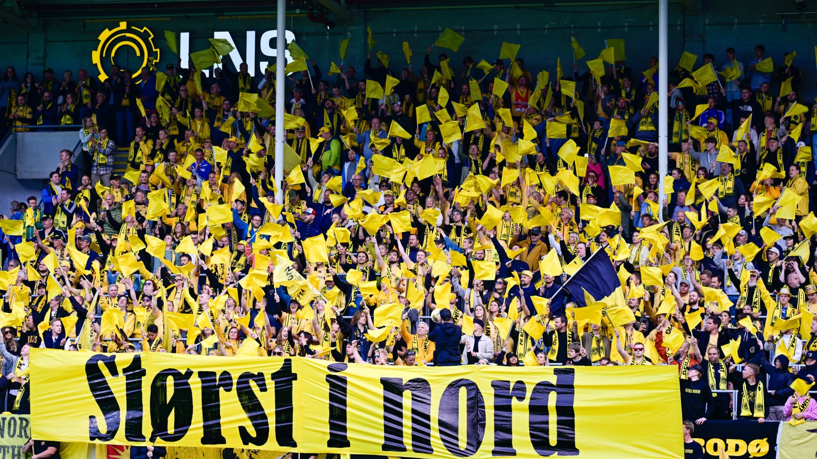 Bodø/Glimts supportere J-feltet holder opp en gul TIFO med teksten "Størst i nord" under slaget om Nord-Norge mellom Bodø/Glimt og Tromsø i cupen 2023.