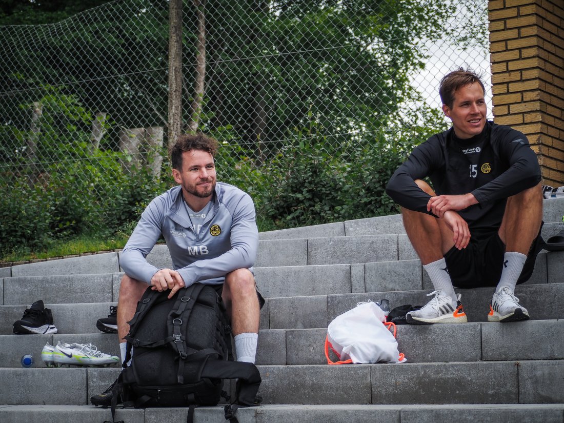 Mike Brown og Anders Konradsen på trappa i Danmark mens de ser på resten av treninga til laget.jpg