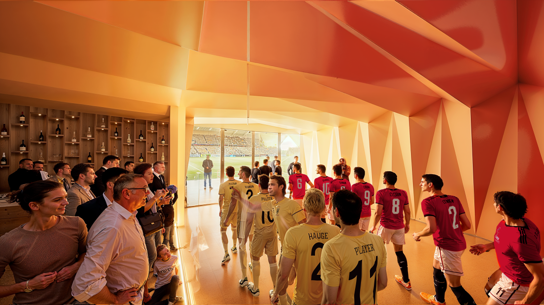 Bildet viser mennesker som står på venstre side av et glassvindu med utsikt rett mot spillertunellen der spillerne har stilt seg opp for å gå inn på banen før kamp.